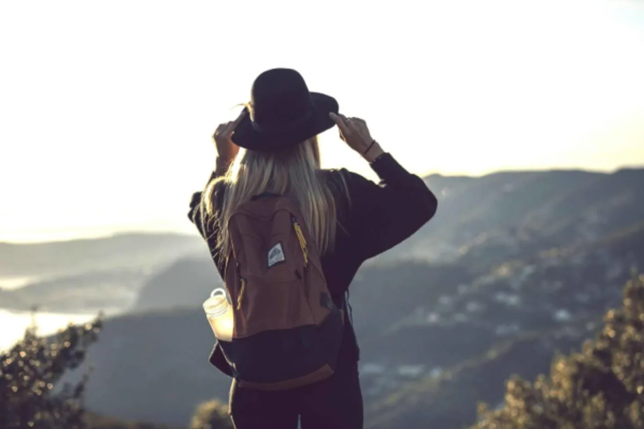 Solo female traveler looking at mountains